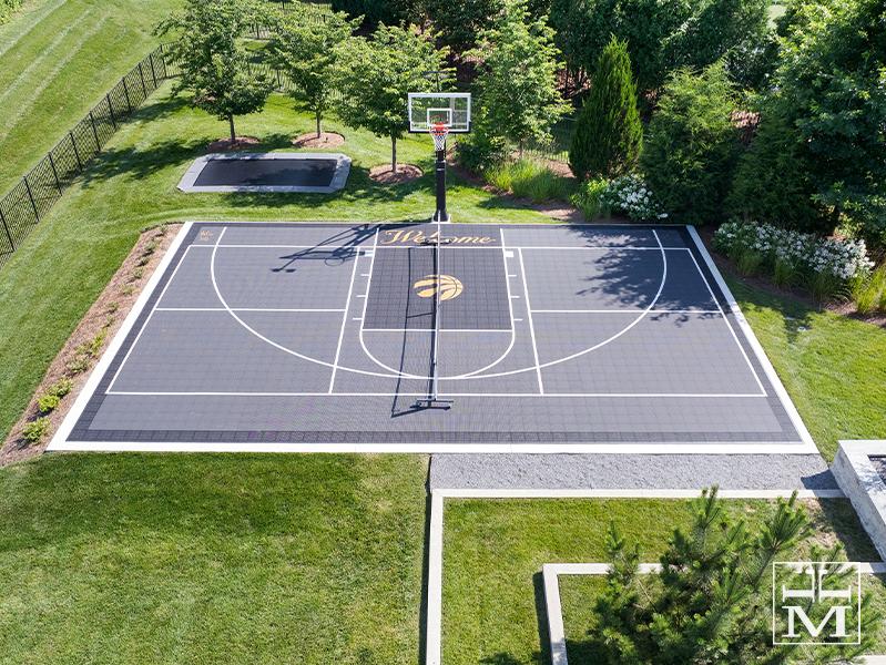 backayrd-basketball-court-with-landscaping-trampoline-DeShayes-Dream-Courts